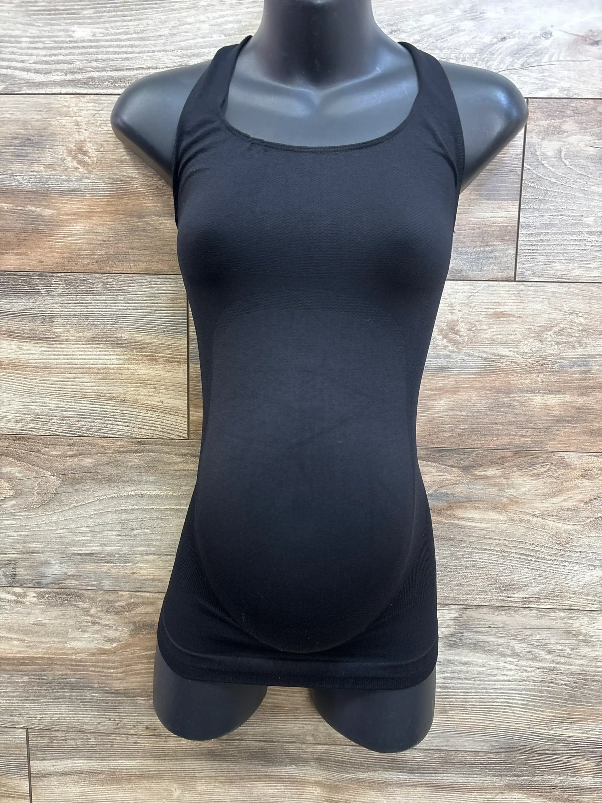 Front view of Blanqi maternity crossback sport tank, black, on mannequin showing built-in belly support and seamless fit