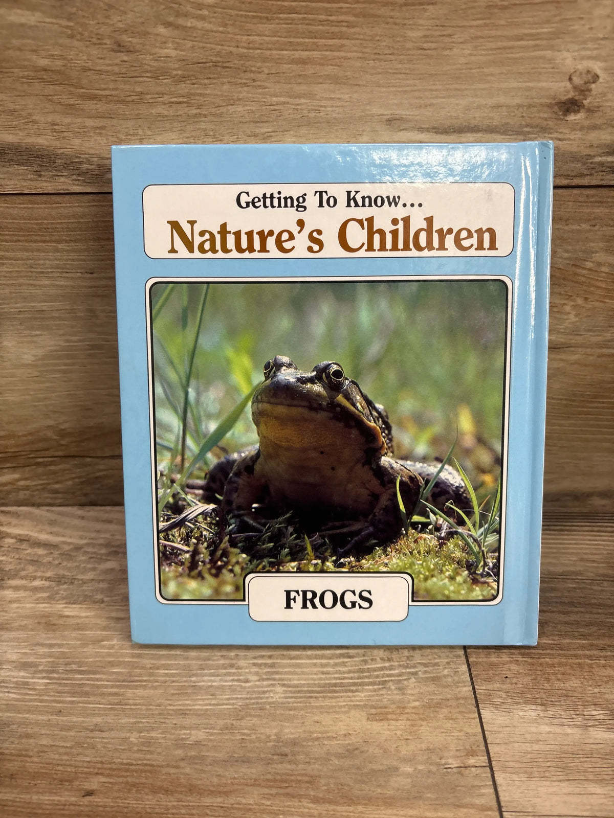 Front cover of Getting to Know Nature’s Children Squirrels and Frogs hardcover book featuring a frog on moss and a blue cover