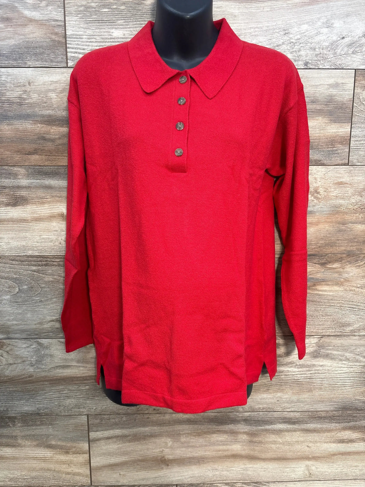 Front view of red maternity CashSoft polo sweater, size M, showing four-button placket, collar and side hem slits on wood background