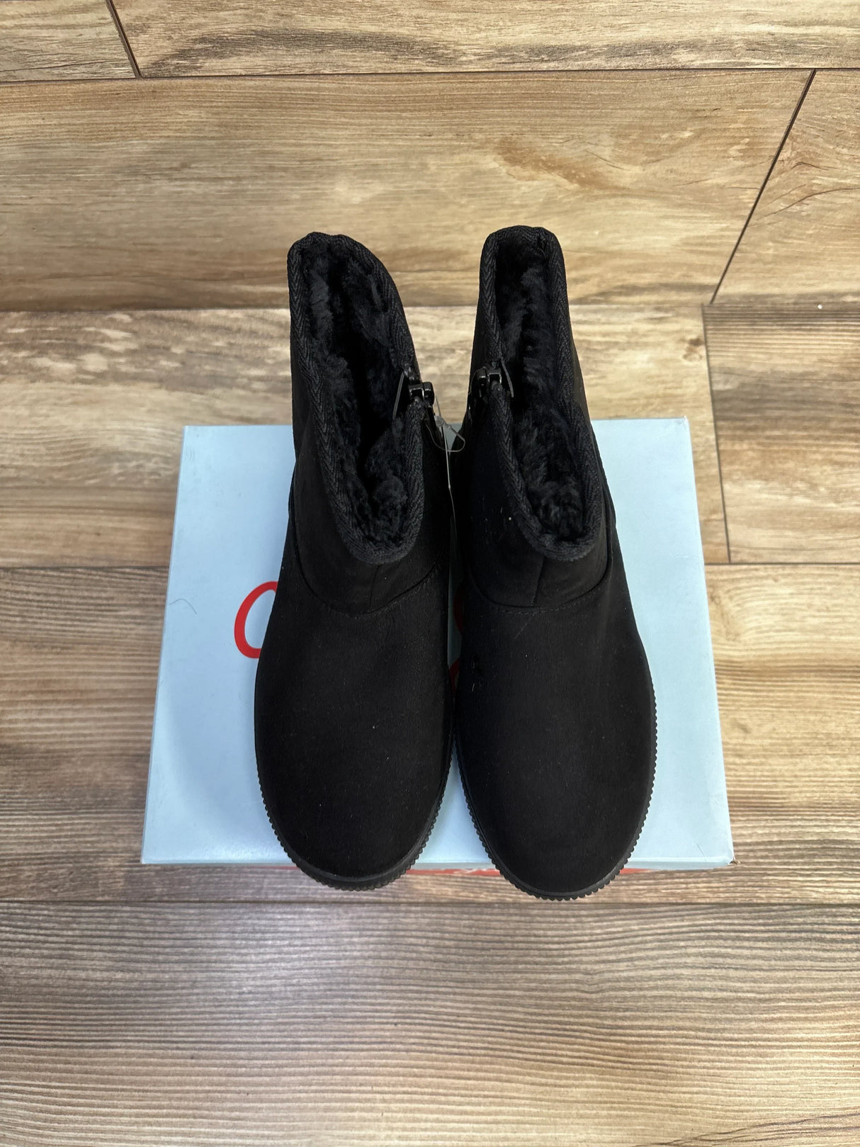 Top-down of Cat & Jack Holland shearling boots size 1Y showing black faux lining and side zippers on a light blue box