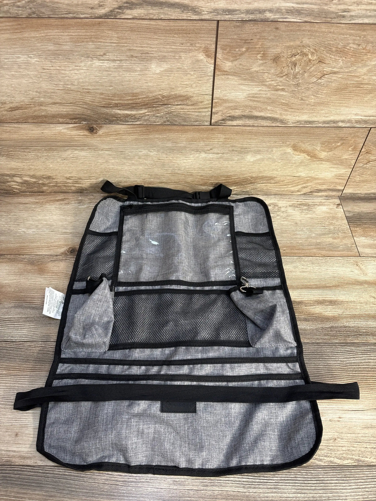 Gray car seat back organizer with pockets on wood floor