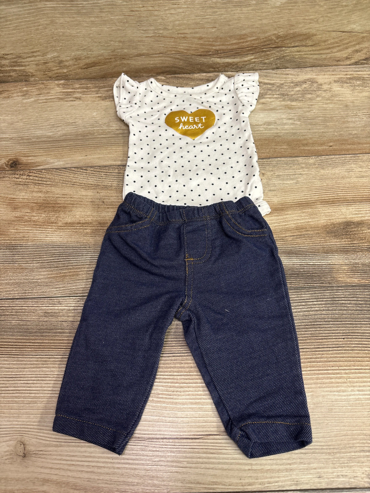 Front view of Carter’s Sweet Heart two-piece set with white polka-dot bodysuit, ruffled sleeves, and dark denim jeggings