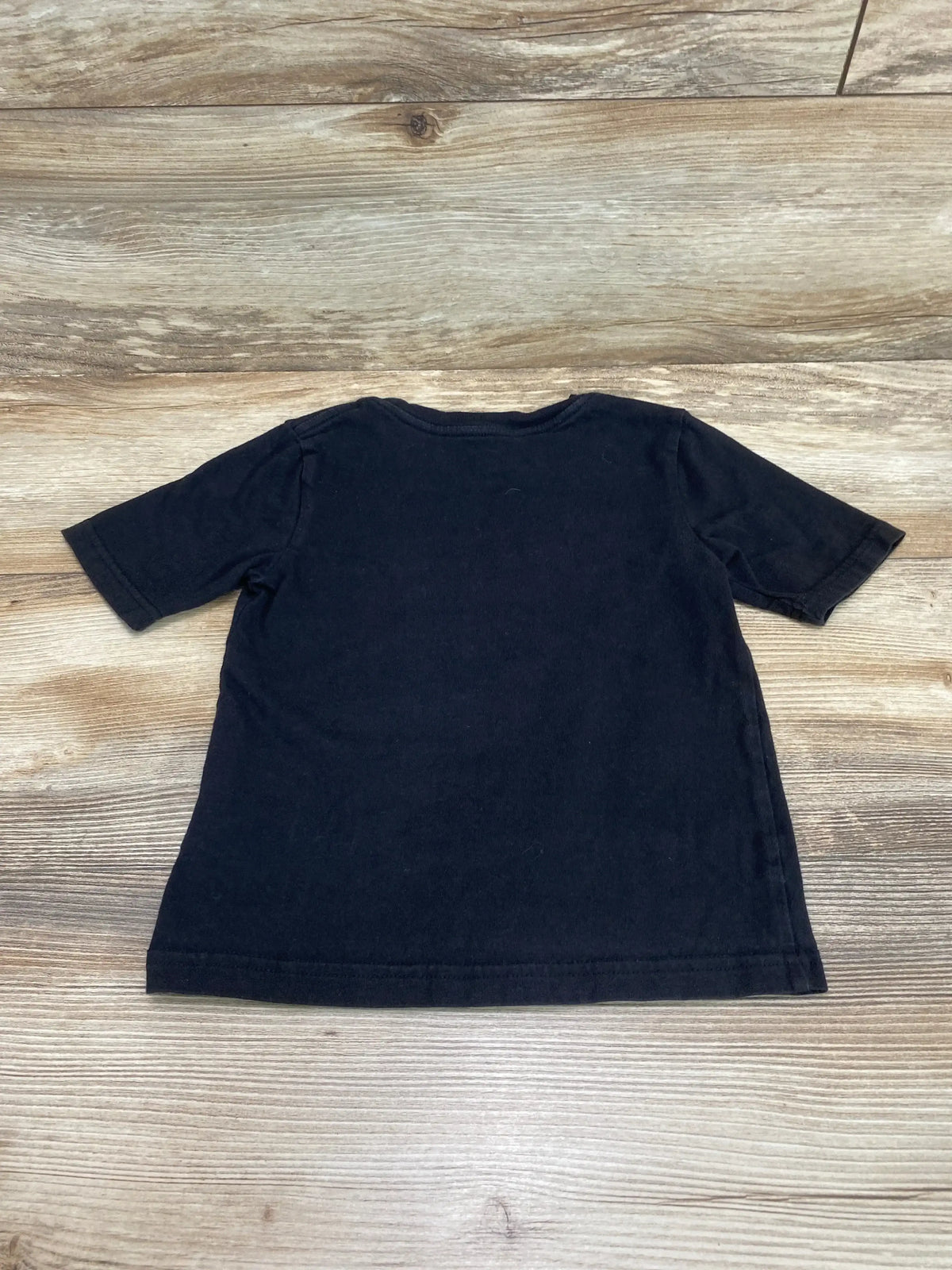 Back view of black toddler Super Bowl LVII T shirt size 4T showing short sleeves and crew neck on wood background