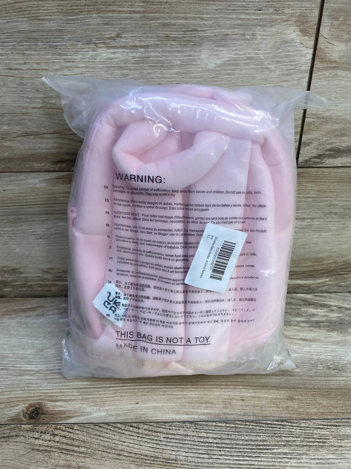 Front view of Gloveleya pink rabbit plush backpack showing stuffed rabbit face, long ears and front zipper pocket on white background