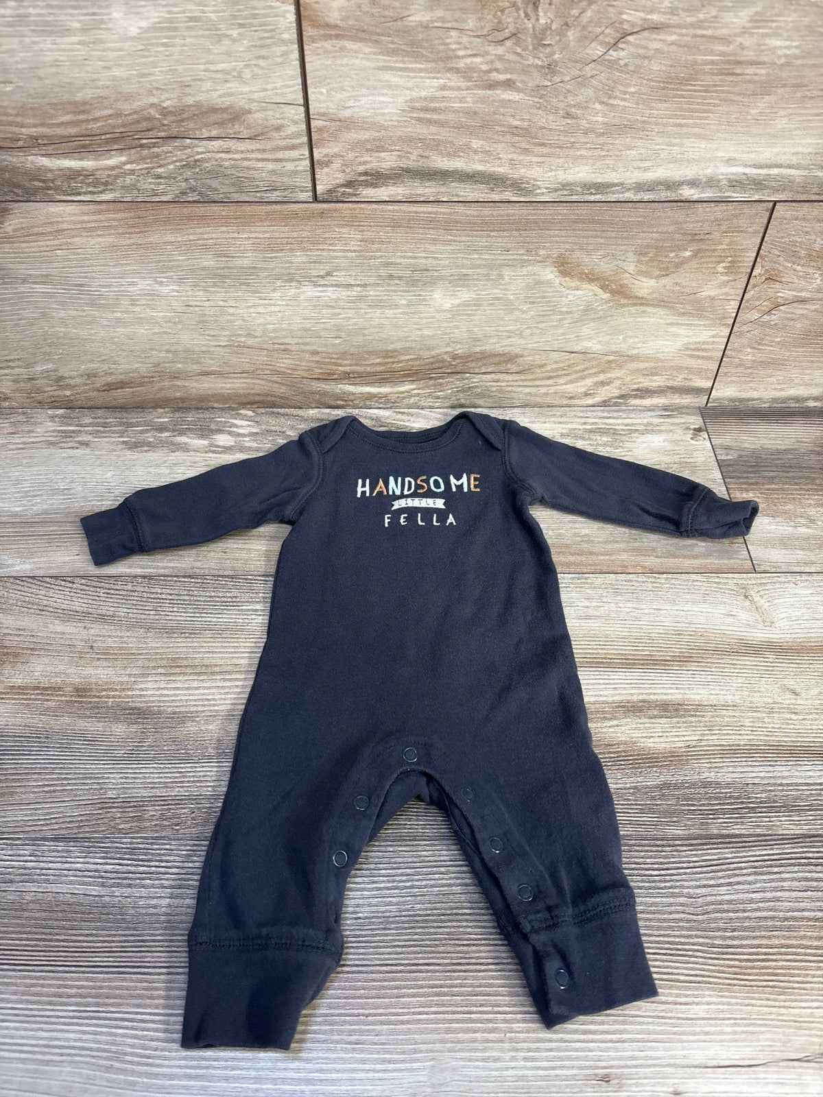 Front view of Carter’s grey baby coverall showcasing Handsome Little Fella print and snap closures on wood-look floor