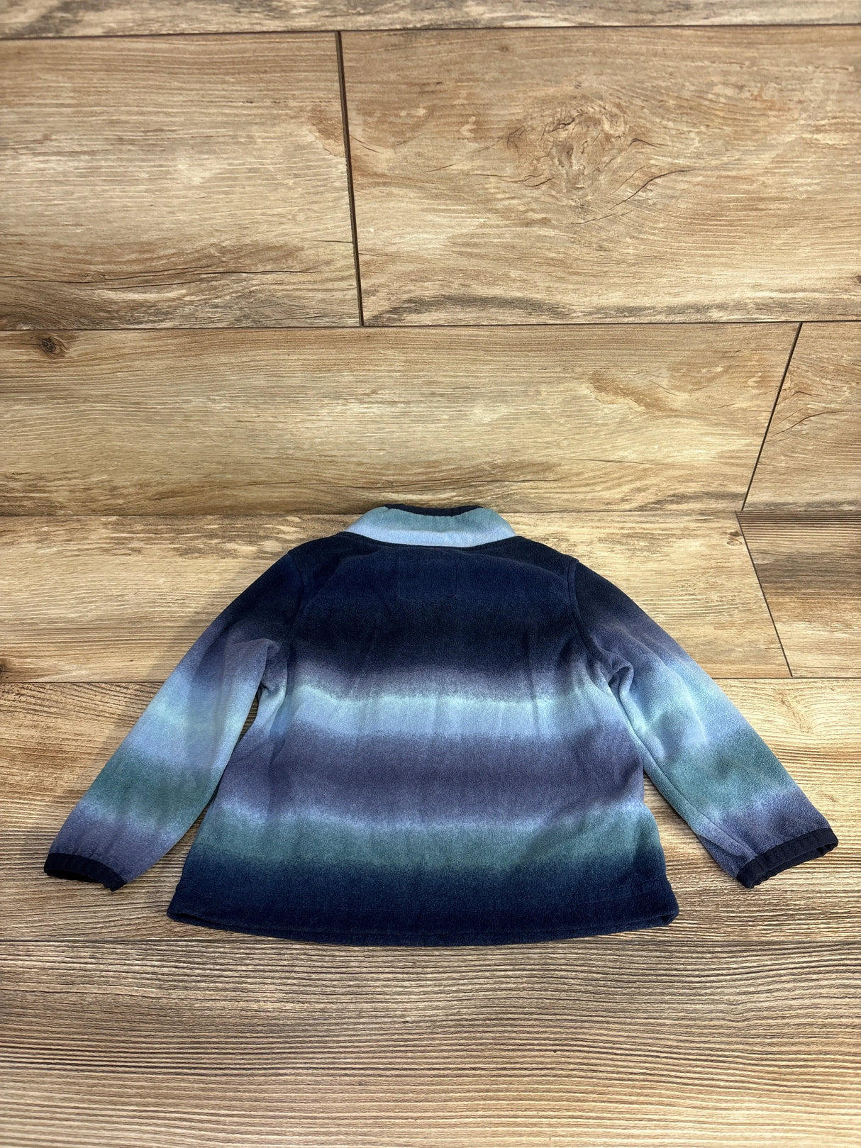 Kids long sleeve jacket with blue and green gradient pattern on wooden floor