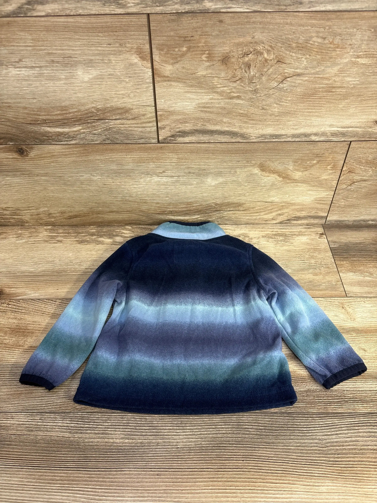 Kids long sleeve jacket with blue and green gradient pattern on wooden floor