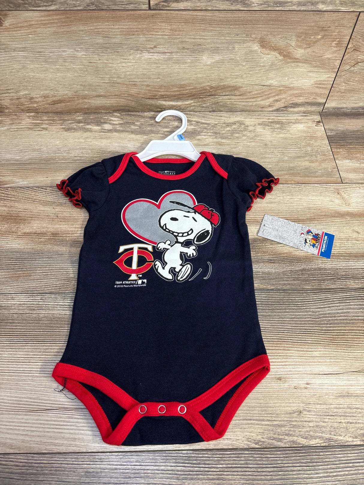 Navy blue baby onesie with red trim featuring Snoopy wearing a red baseball cap and Minnesota Twins logo