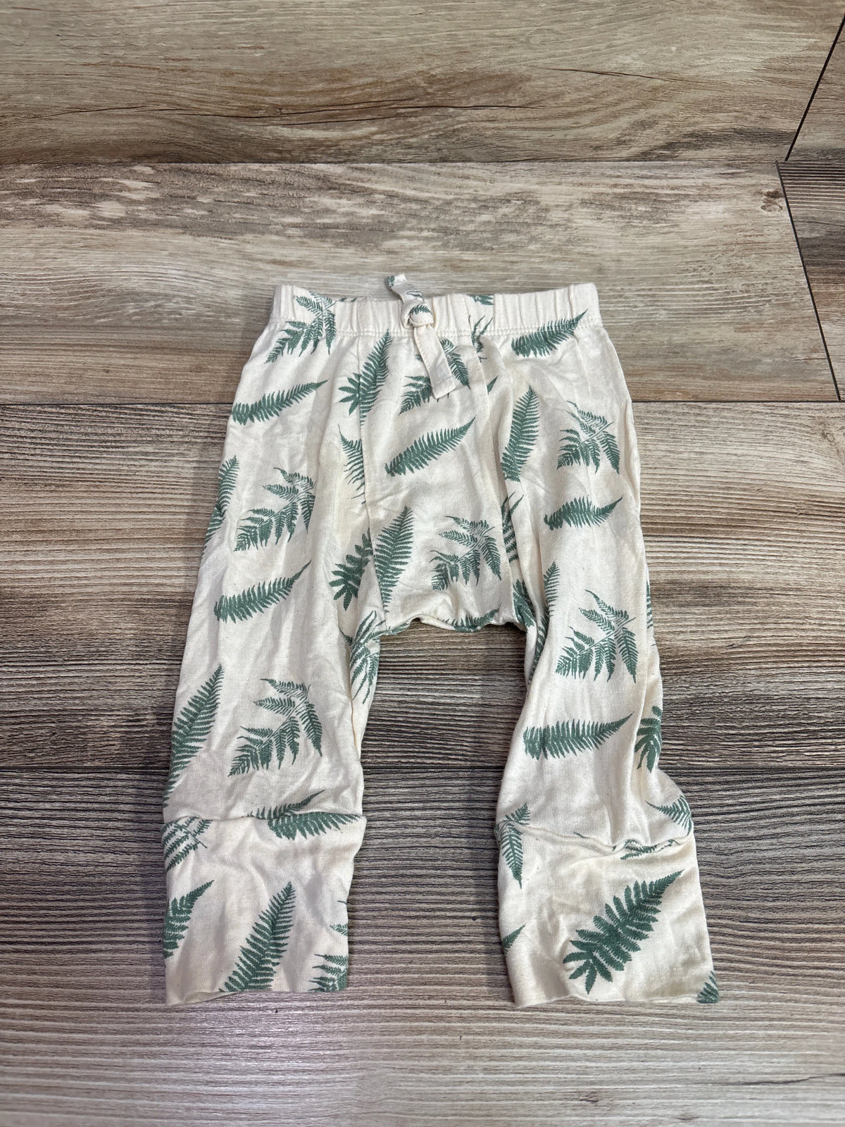 Kate Quinn tan bamboo baby pants with green fern leaf print, size 6-12m