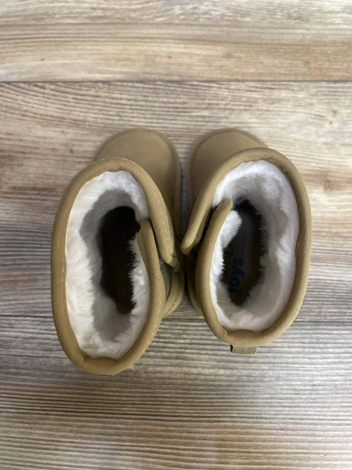 Top view of Simple Joys faux fur suede toddler boots size 4C showcasing white faux fur lining and tan suede on wood floor