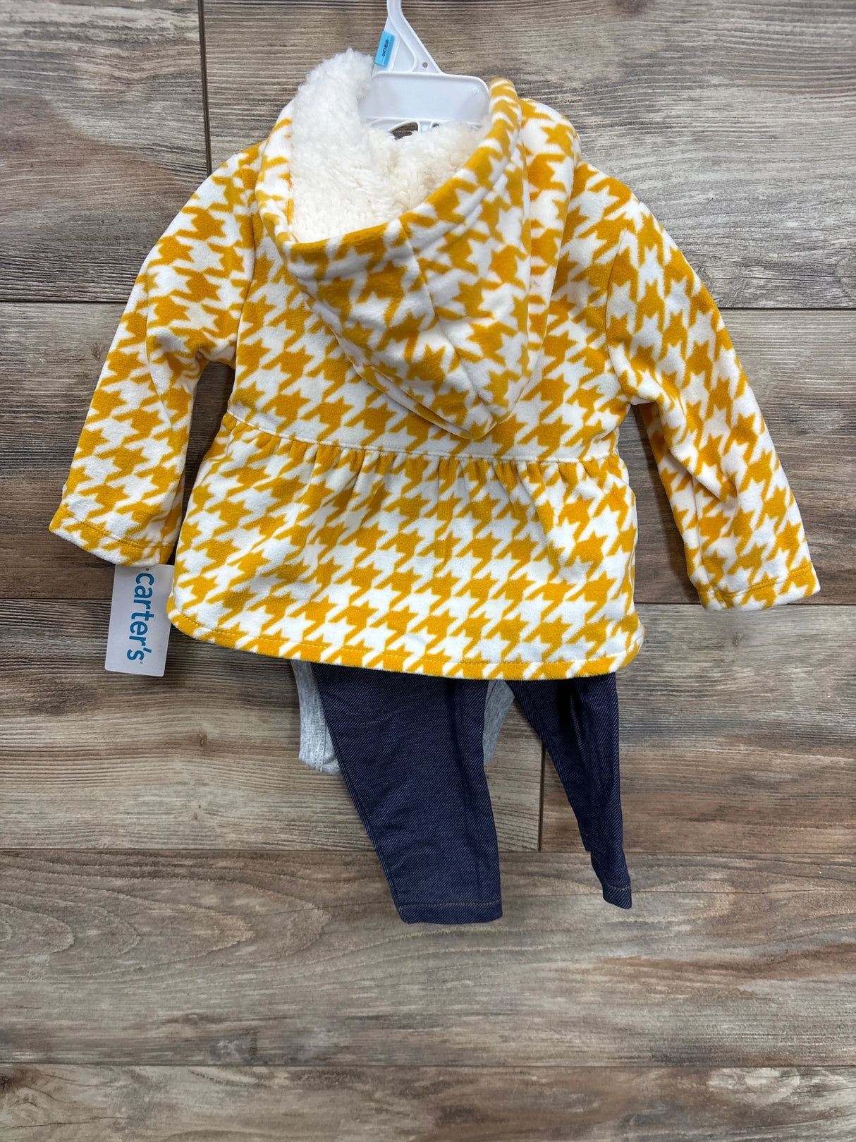 Carter's toddler outfit with yellow and white houndstooth fleece hoodie and navy blue pants on wooden background