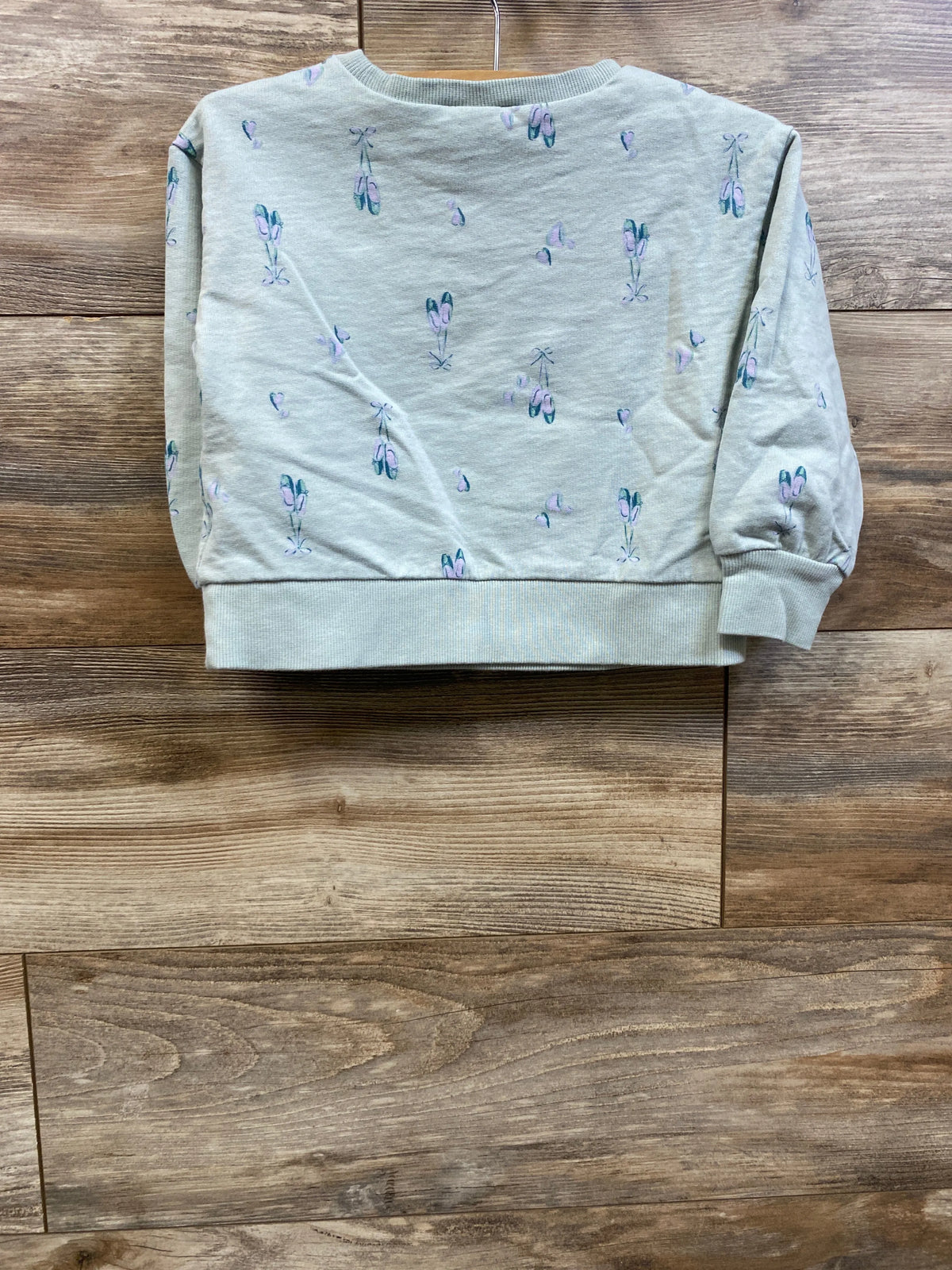 Front view of Carter’s mint pullover sweatshirt in size 3T showcasing ballet shoe print on a wooden background