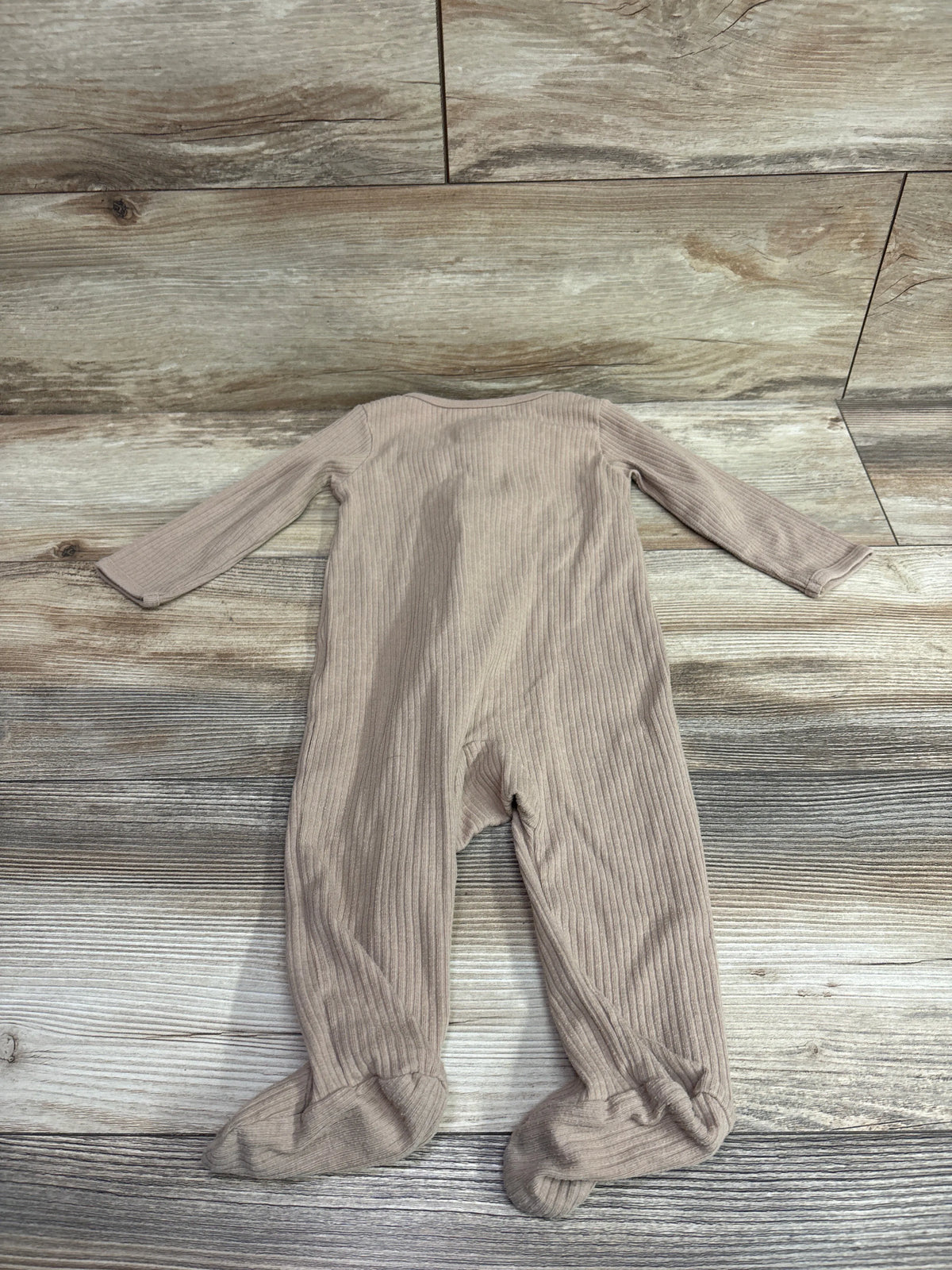 Brown ribbed baby sleeper by Me n Mommy To Be laid flat on a wooden background.