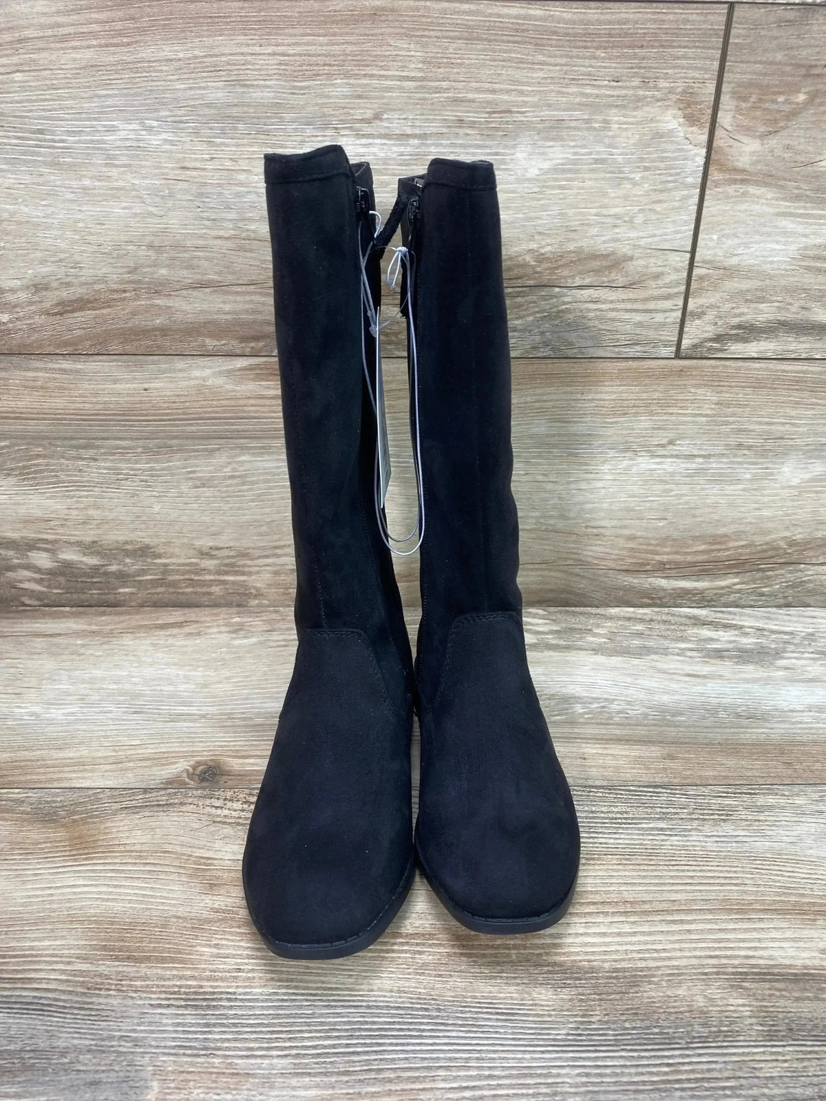 Front view of Cat and Jack Mylah tall black riding boots with suede-like upper, inner zipper and flat sole on wood background