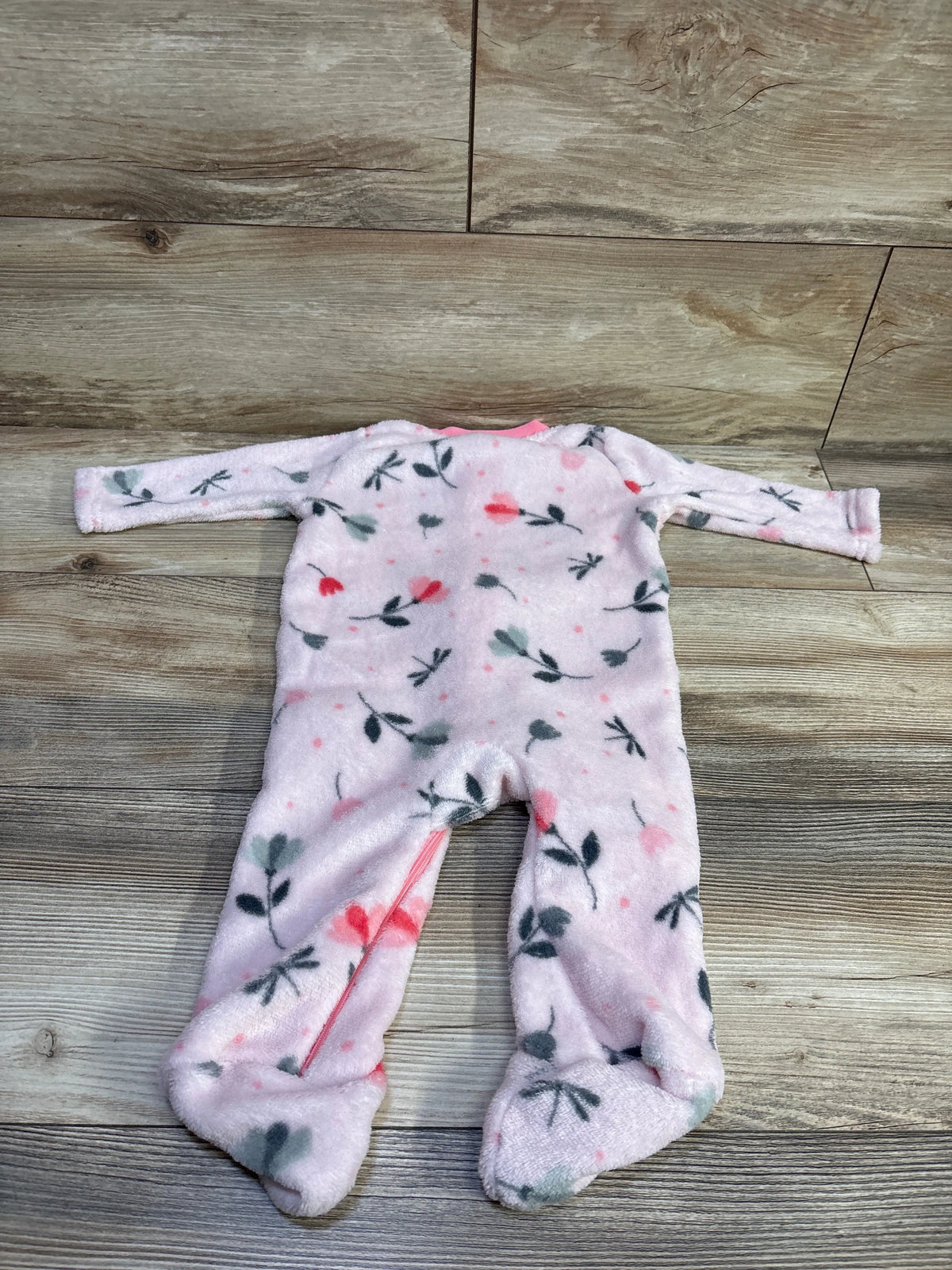 Pink Zak & Zoey baby blanket sleeper with floral print on a wooden background