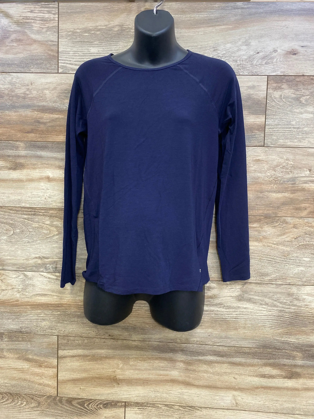 Front view of Gap maternity long-sleeve navy shirt on mannequin with breathable fabric and raglan seams against wood background