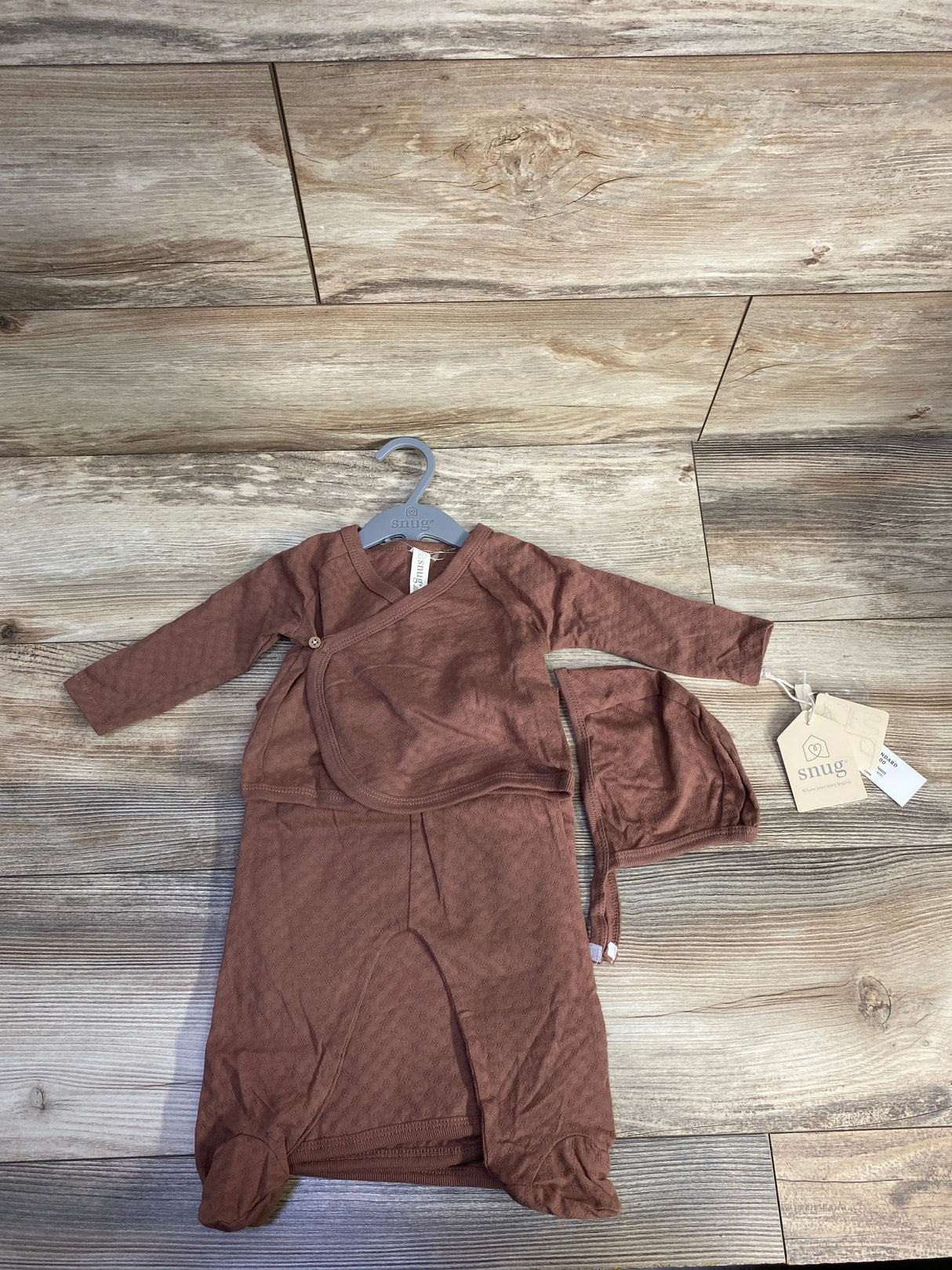Brown baby kimono gown and hat set on hanger, wood background, Snug brand tags