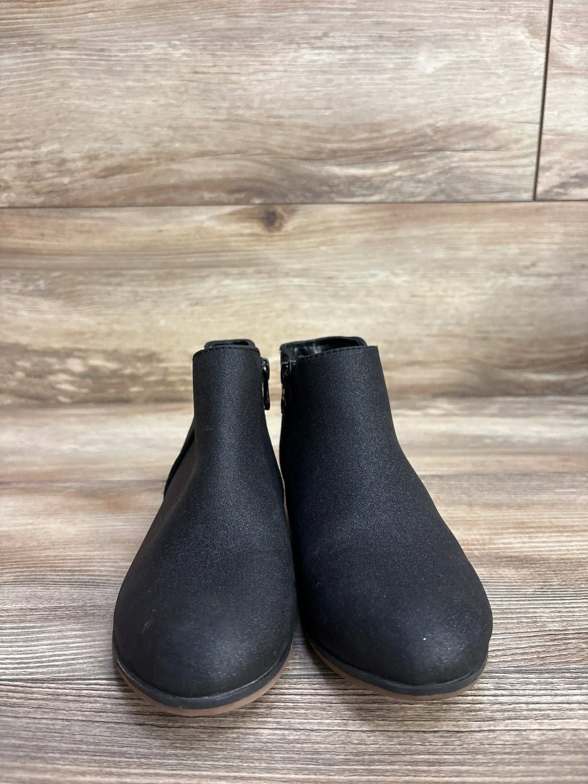 Front view of Cat & Jack glitter ankle boots in black, size 13C, showing rounded toe and low heel on wood background