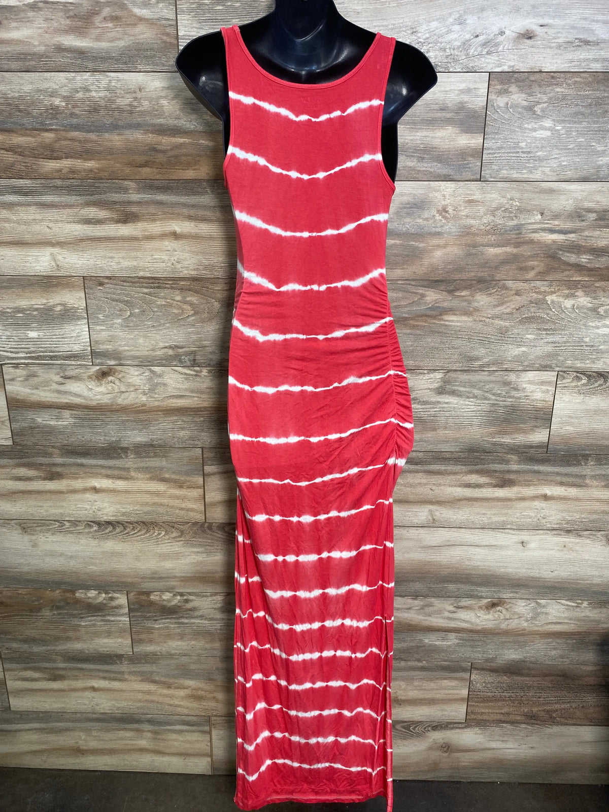 Front view of Isabel maternity bodycon mini dress showing red tie-dye, sleeveless crewneck and side shirring on mannequin