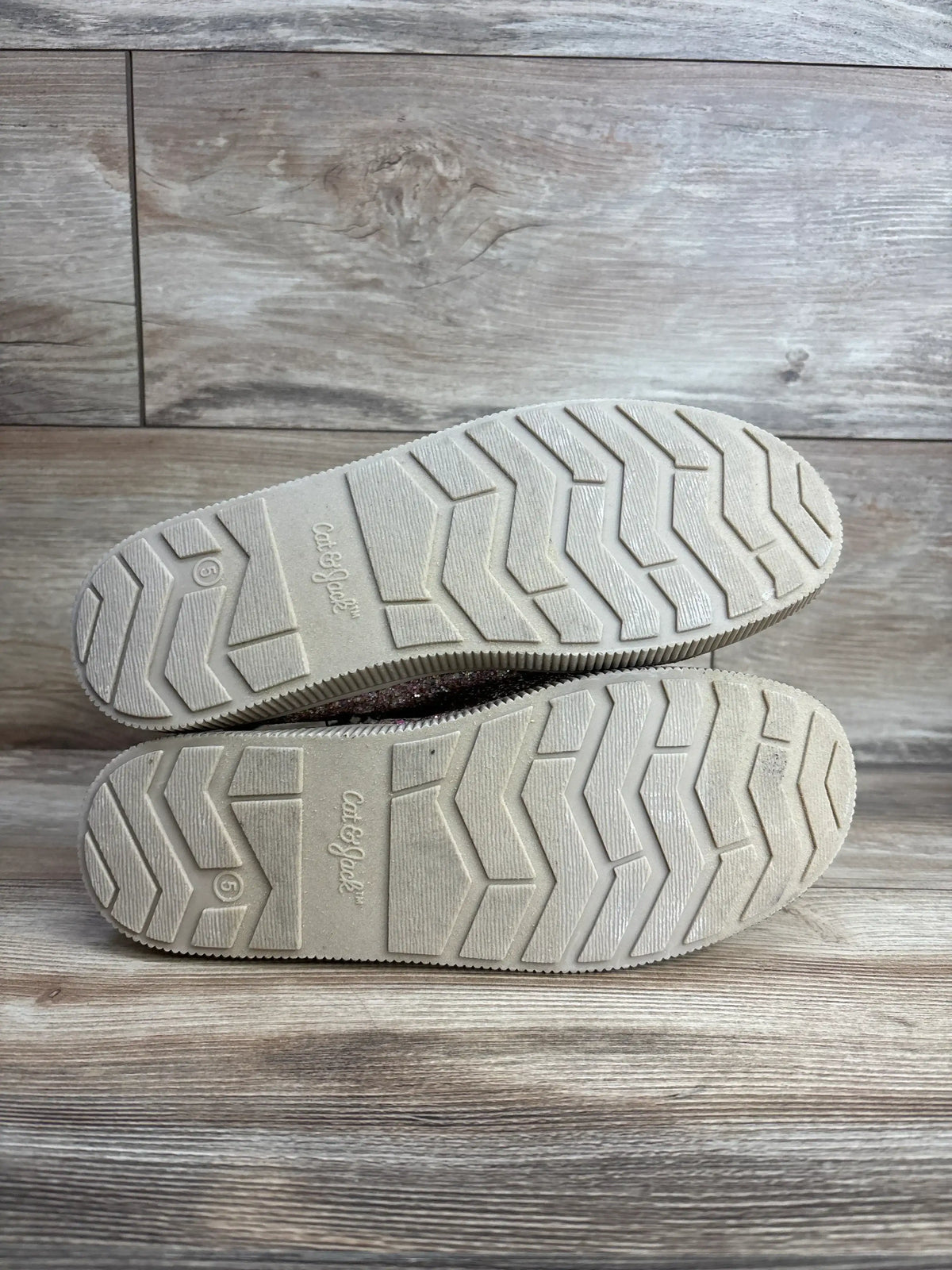 Cat & Jack toddler shoes soles with zigzag tread, size 6, on wooden floor