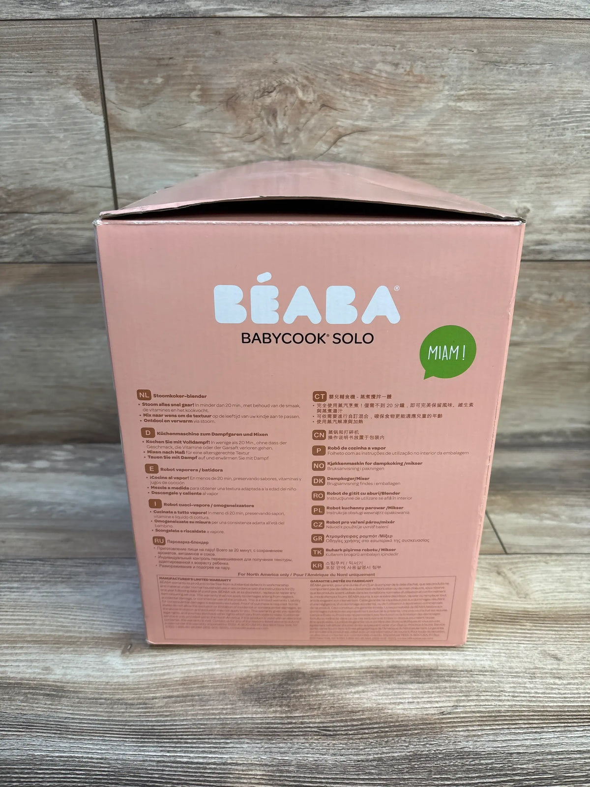 Rear view of the rose gold Beaba Babycook Solo food processor box showing steam cooking and blending features