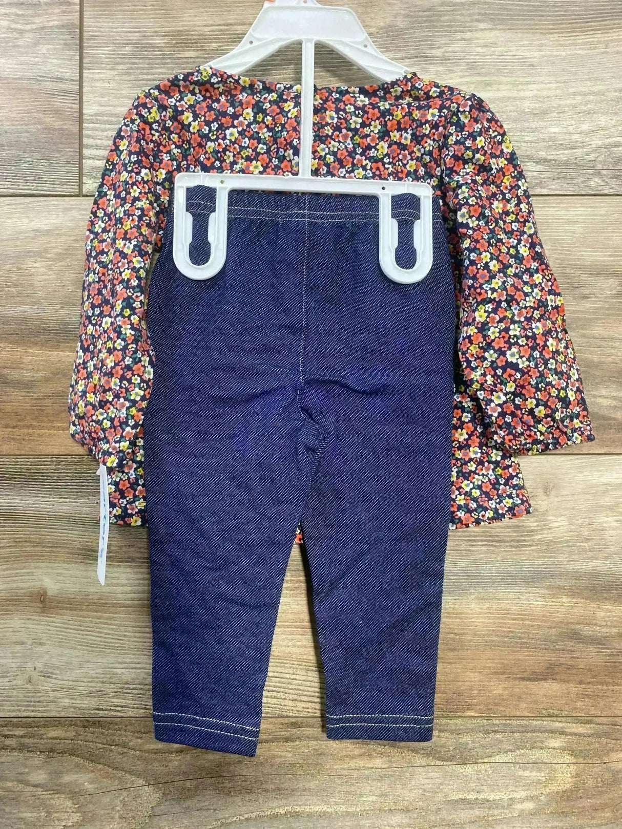 Back view of Carter’s two-piece set showcasing a navy floral long-sleeve top and navy jegging leggings on wood floor