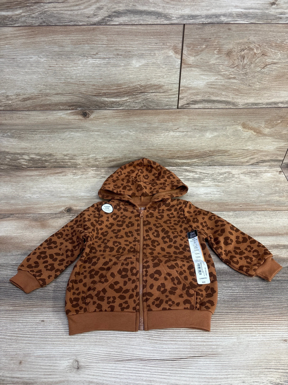 Brown leopard print toddler zip-up hoodie with hood on wooden surface