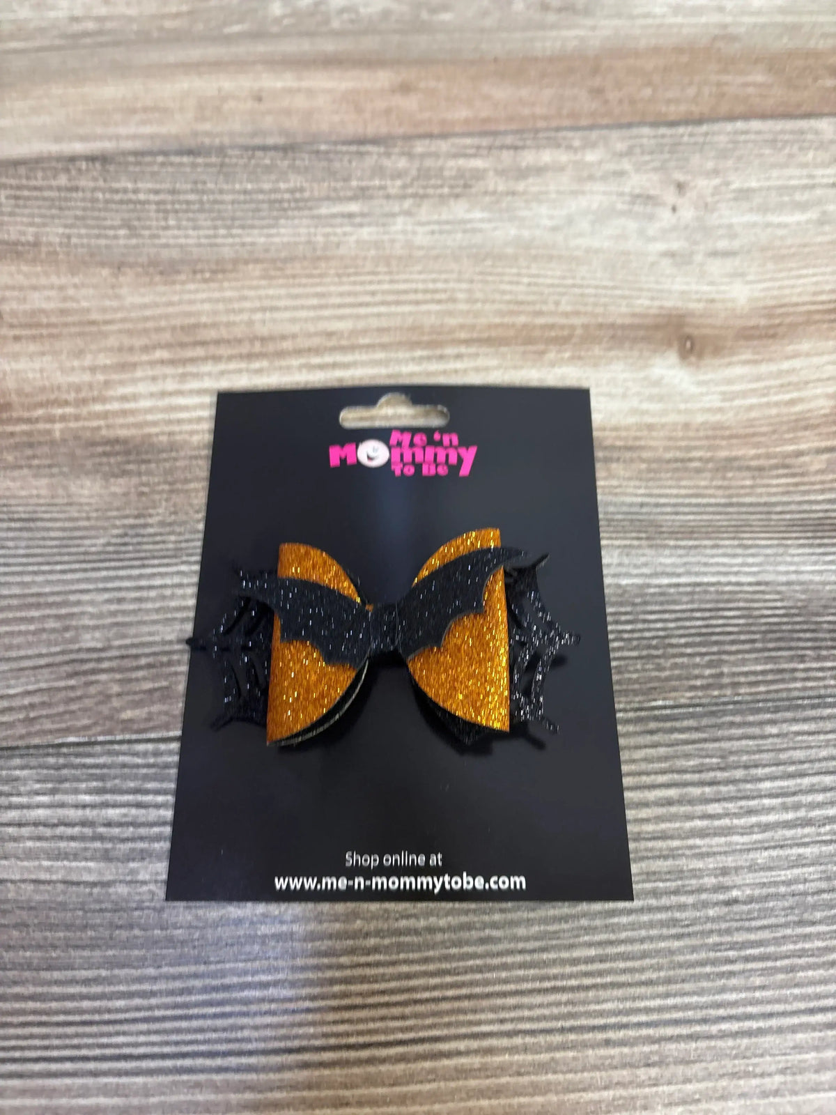 Halloween bat hair bow with orange glitter and black wings, perfect for kids' costume accessories.