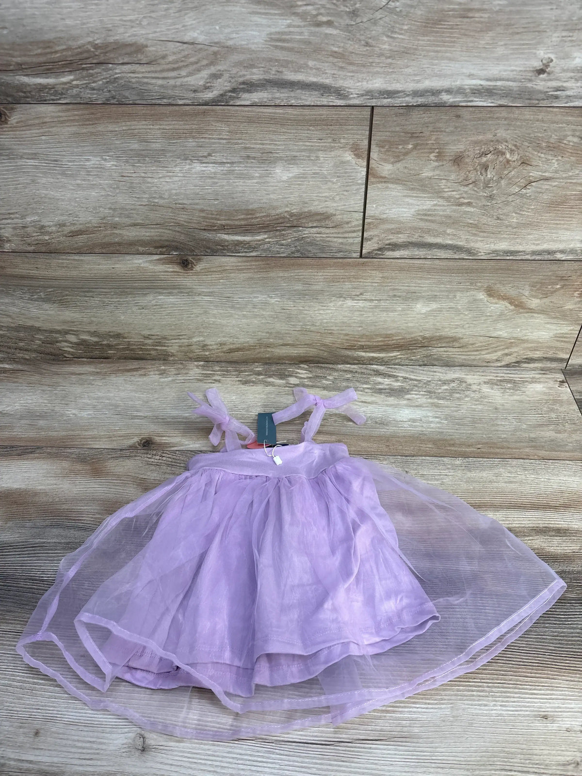 Front view of Bailey’s Blossoms lilac sleeveless tulle dress, size 9 to 12 months, with layered skirt on wood floor