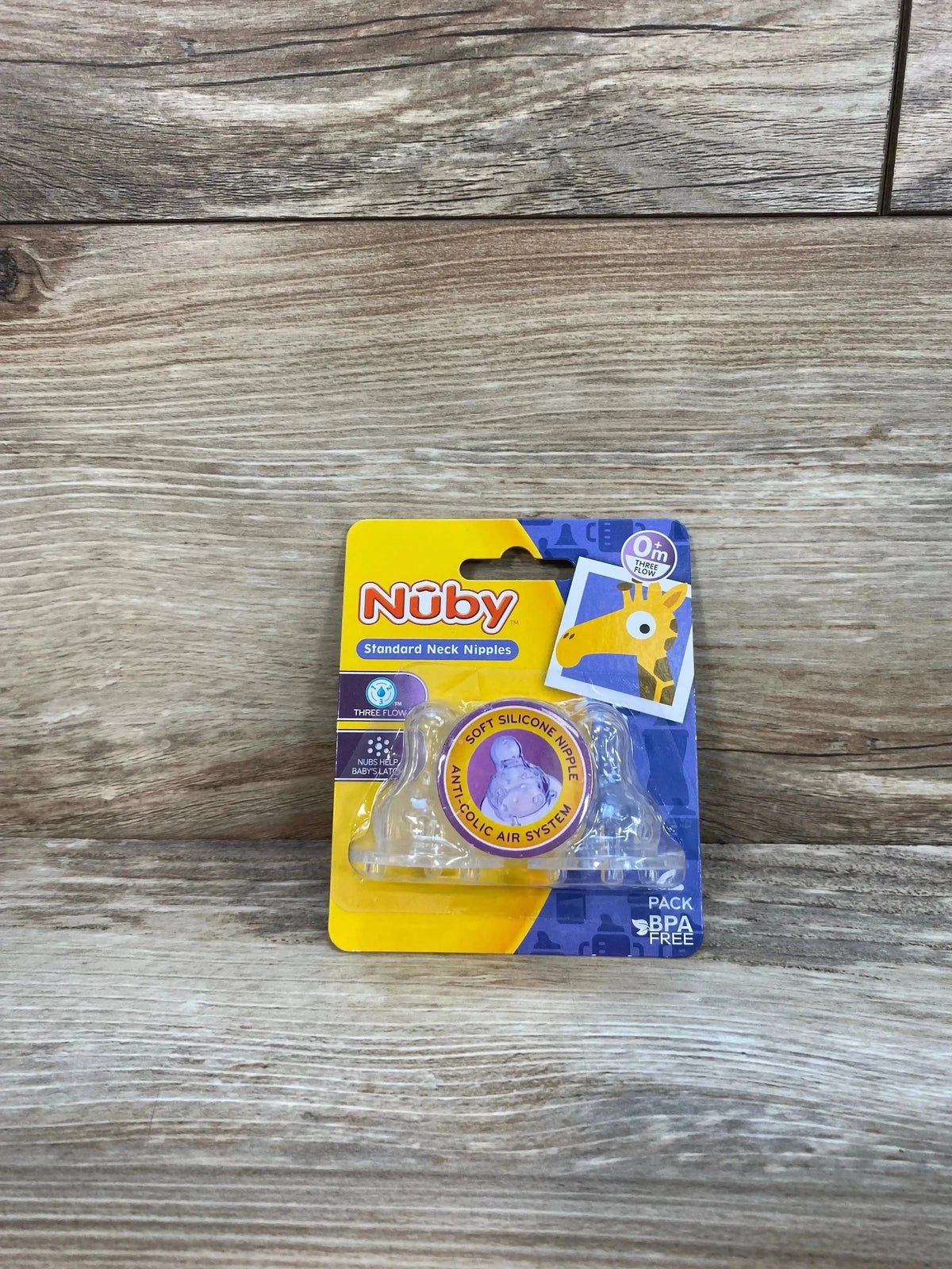 Front view of Nuby 2-pack standard neck silicone nipples showing three-flow anti-colic design and BPA-free pack on wood background