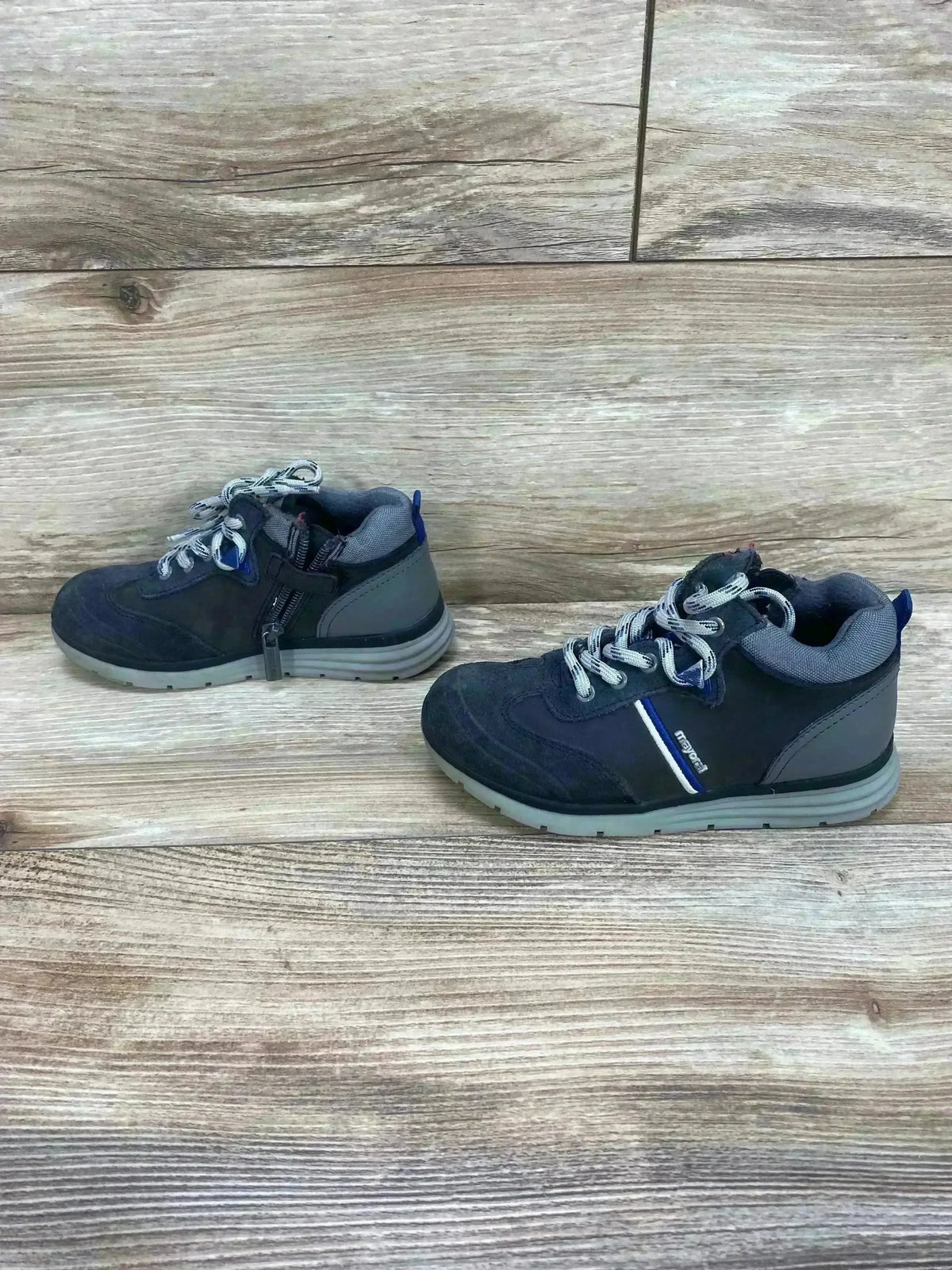 Side view of Mayoral Colorblock city sneakers in gray showing lace up front, side zipper, rubber sole on wood background
