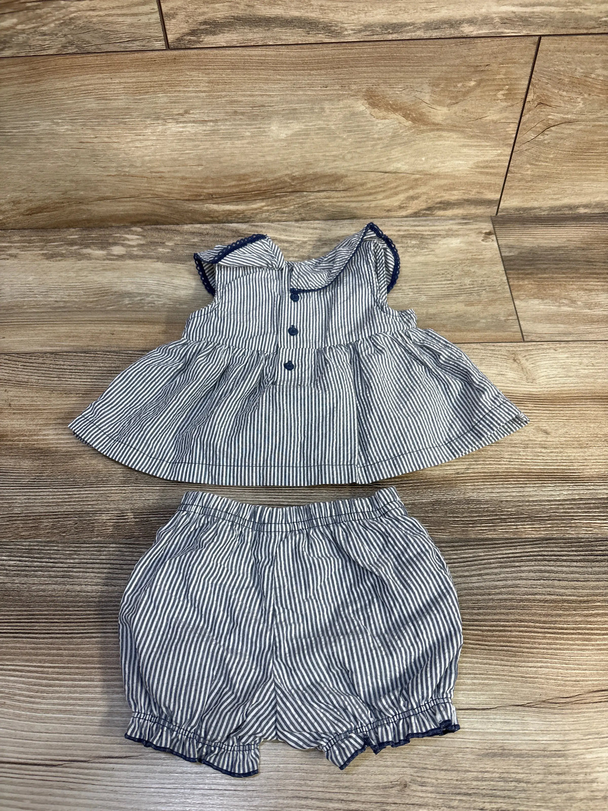 Just One You striped top and bloomers set with front buttons and ruffled hems on a wood grain background