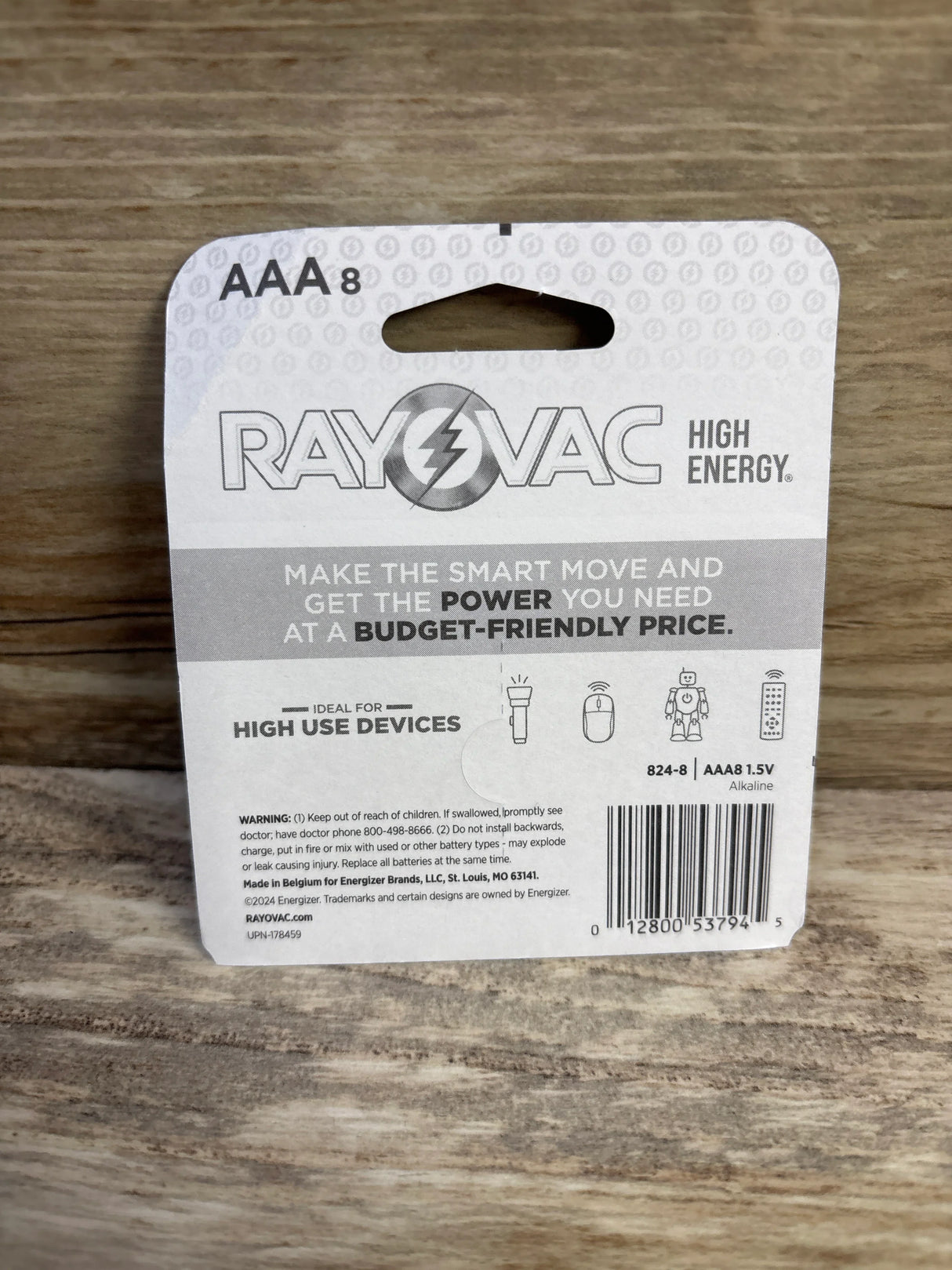 Back of Rayovac High Energy AAA 8-pack showing Make the smart move headline, usage icons and warning on wood background