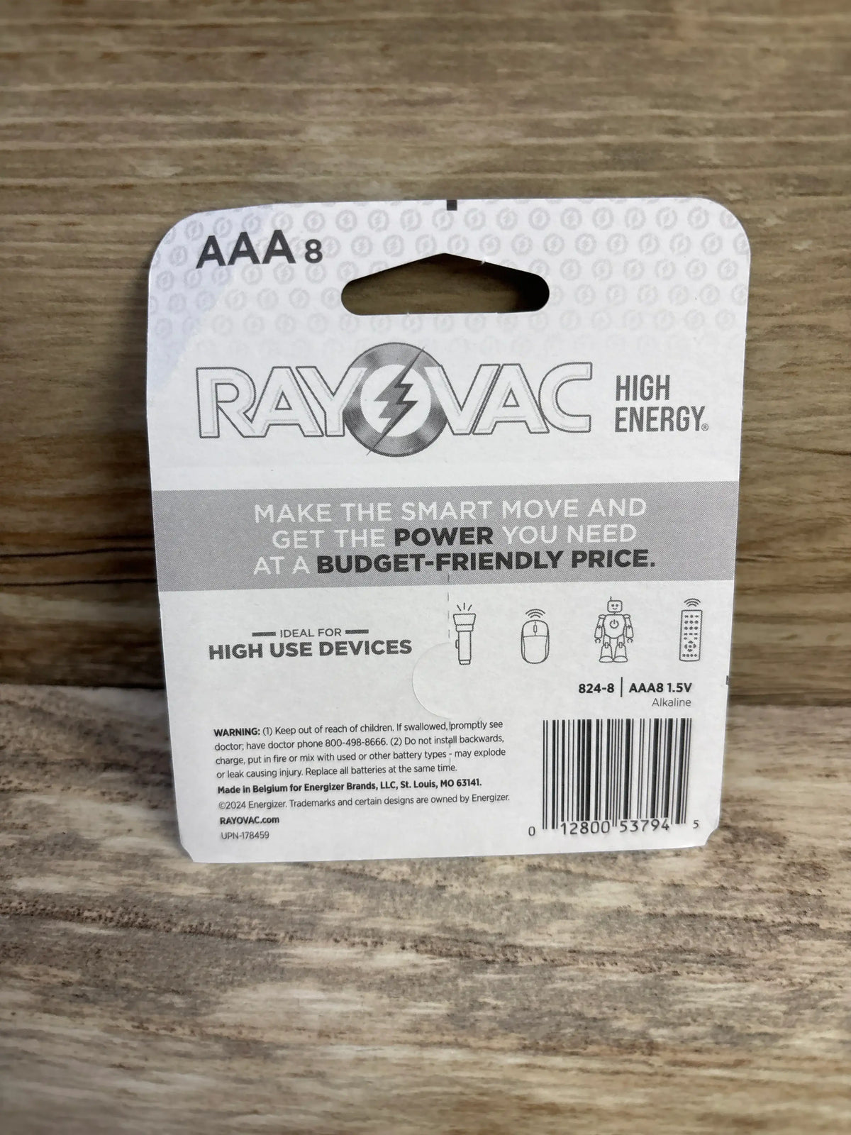 Back of Rayovac High Energy AAA 8-pack showing Make the smart move headline, usage icons and warning on wood background