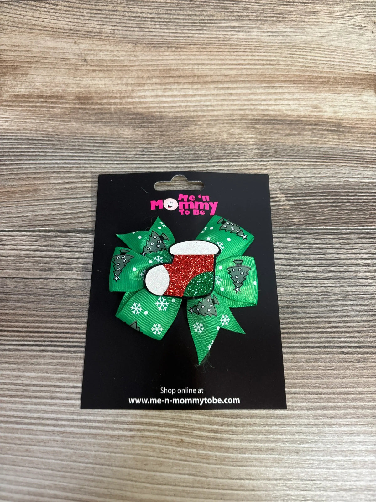 Green Christmas tree and snowflake hair bow with red glitter center, perfect for kids' holiday outfits.