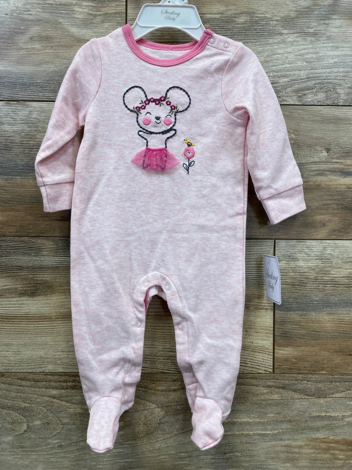 Pink baby sleeper with mouse and flower embroidery, long sleeves, footed design on wood background