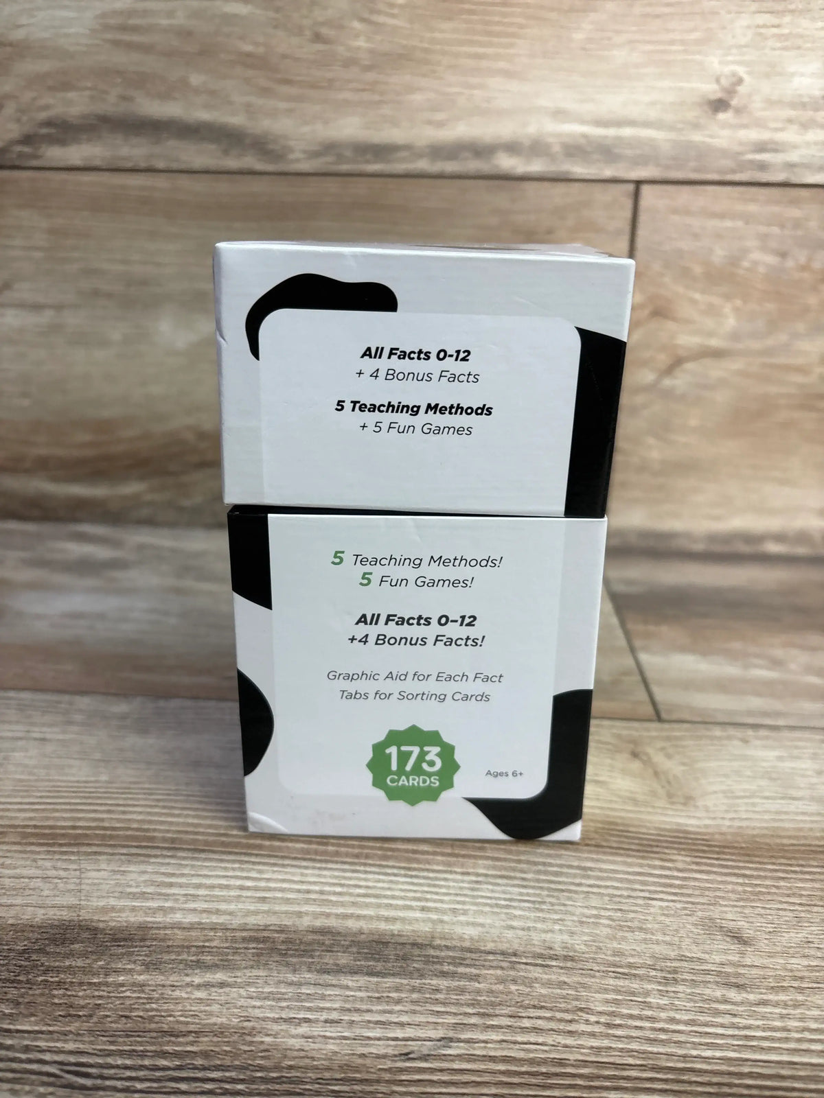 Front of Think Tank Scholar addition flash cards showing All Facts 0-12 plus 4 Bonus Facts and 173 cards badge on wood floor