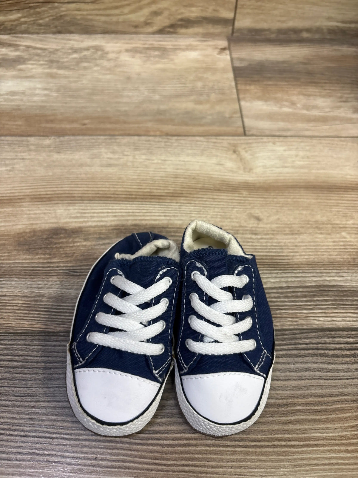 Top view of Converse All Star Cribster Easy-On Shoes in navy, size 3C, showcasing white laces and toe caps on a wood floor