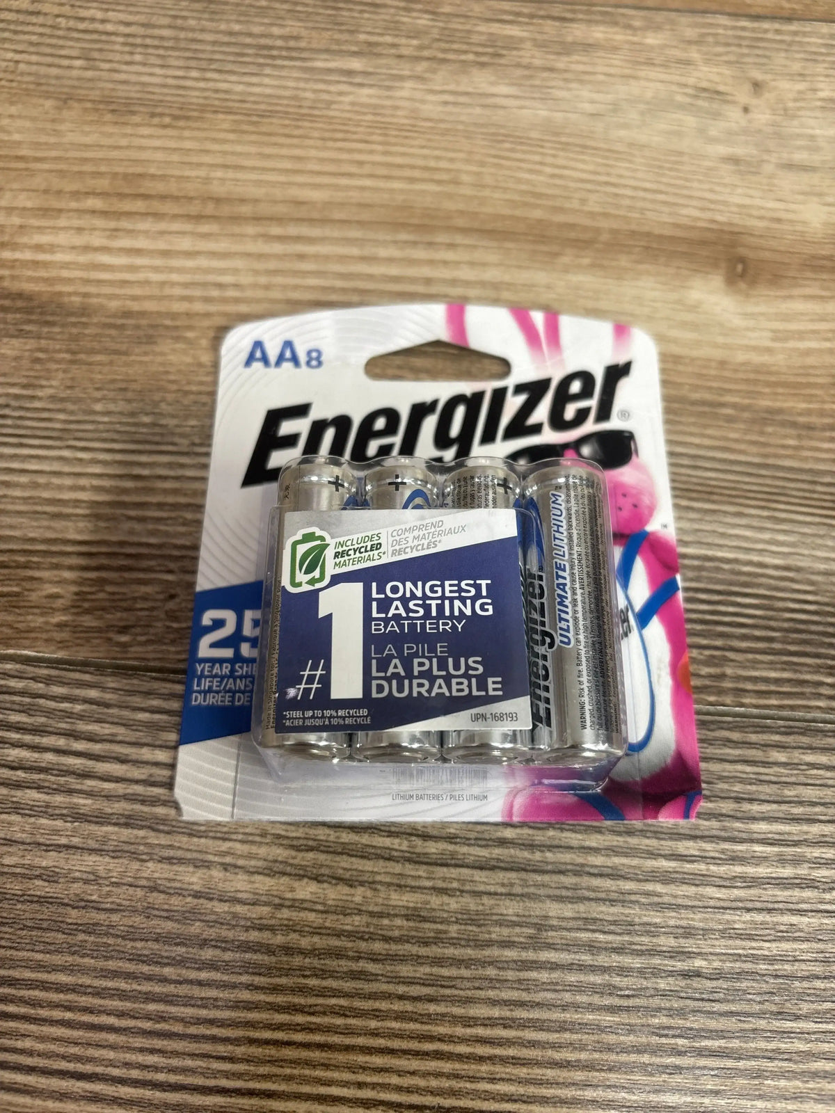 Front view of Energizer Ultimate Lithium AA 8-pack showing Longest Lasting Battery label on wooden table background