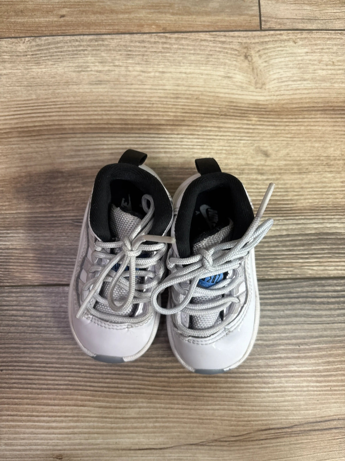Top view of Air Jordan 11 Retro TD Legend Blue Columbia sneakers, size 4C, showing white and gray uppers