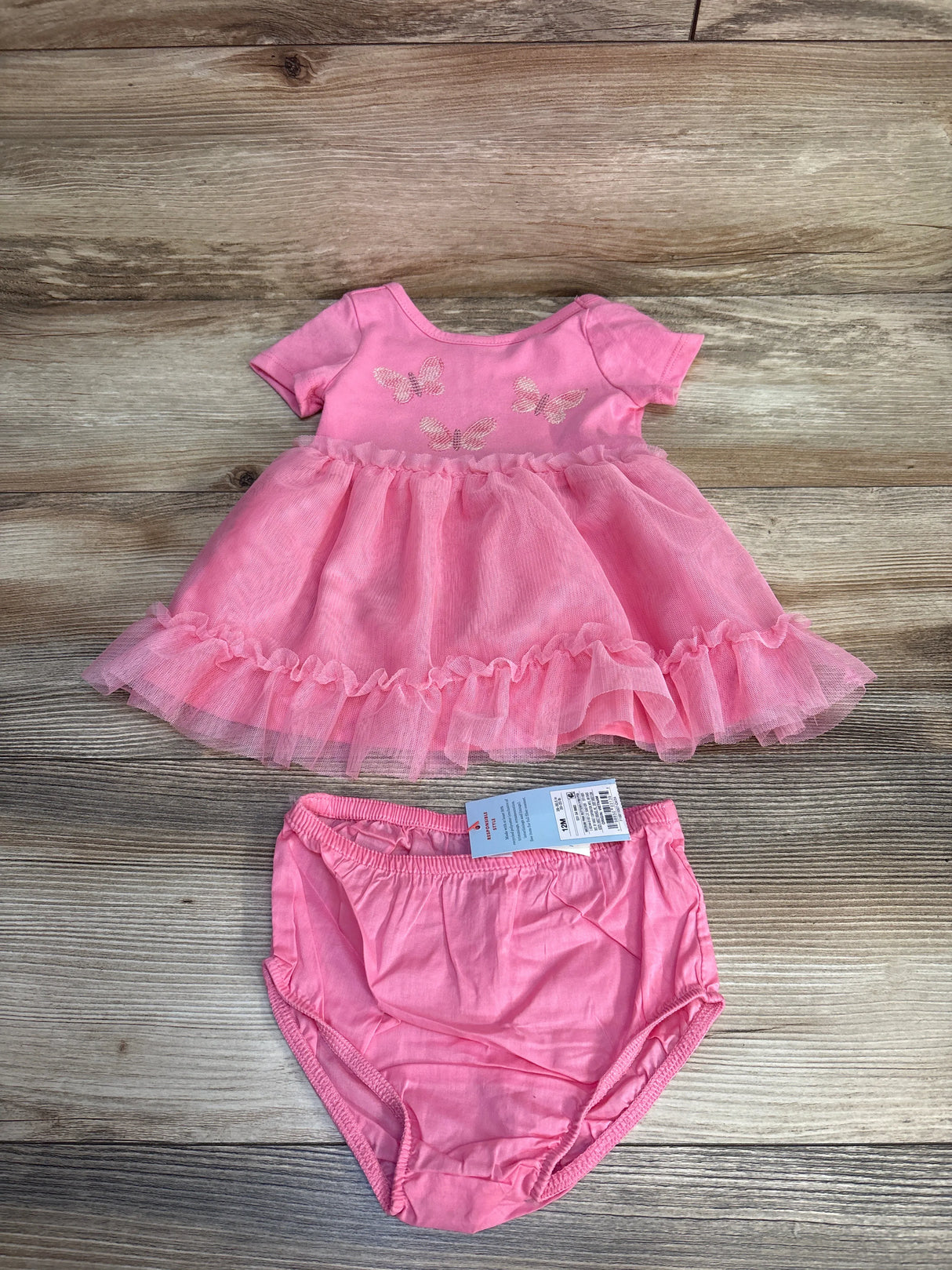 Pink baby dress with butterfly print and matching bloomers, ideal for kids' clothing resale