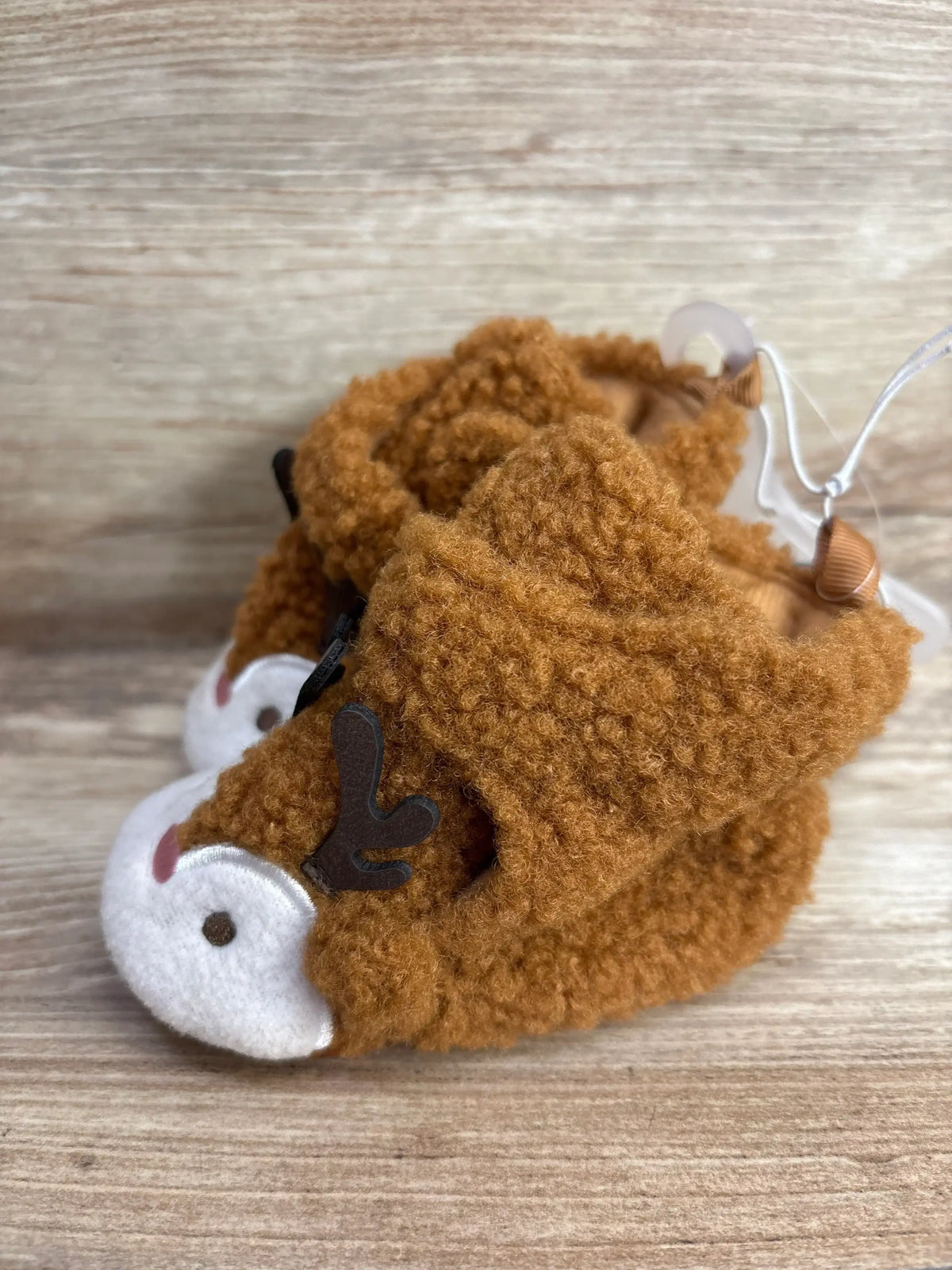 Cozy brown fuzzy reindeer baby shoes with antlers, perfect for infant holiday outfits