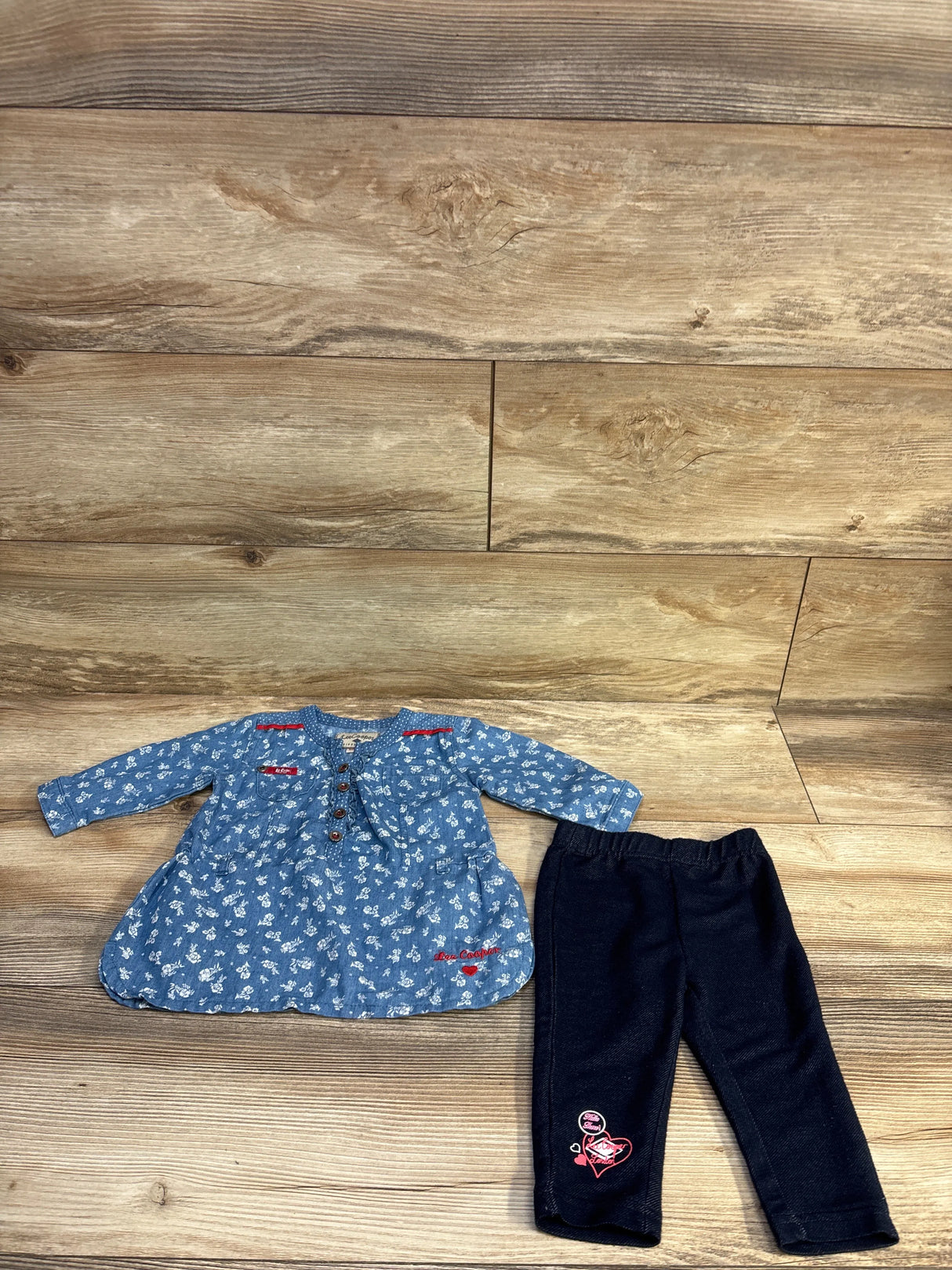 Flat lay of chambray dress and navy jeggings set showcasing button-front detail and elastic waist on wood background