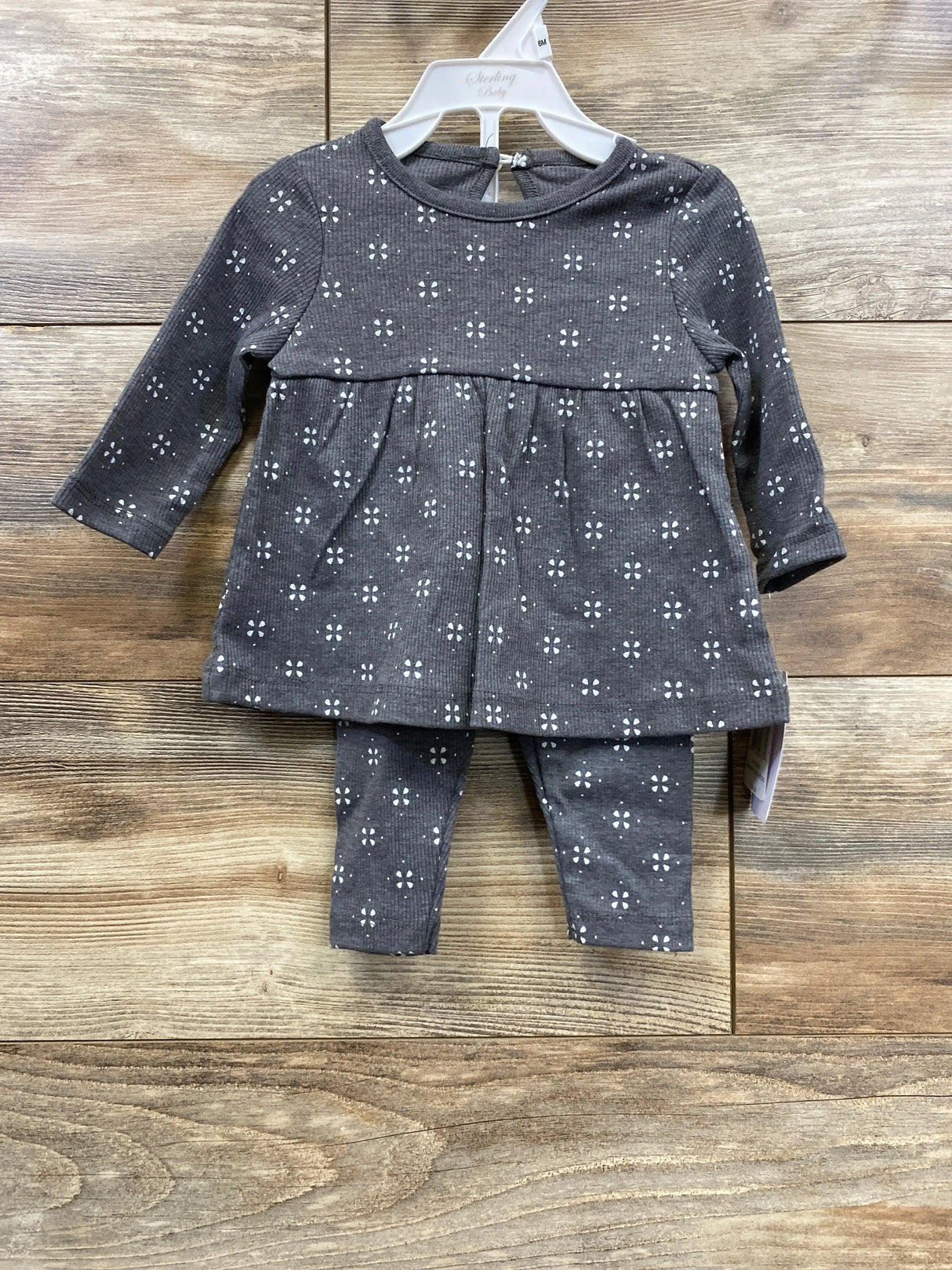 Gray baby outfit with white floral pattern, long-sleeve top and matching pants set