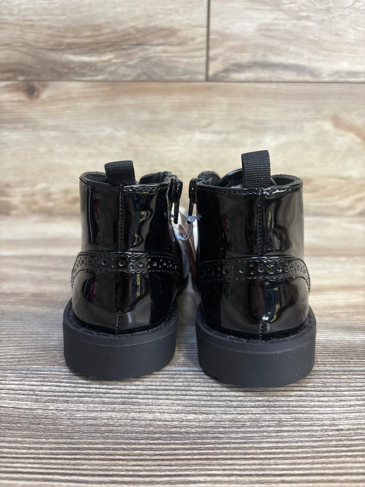 Black patent leather baby boots with platform soles and back pull tabs, perfect for toddler fashion.