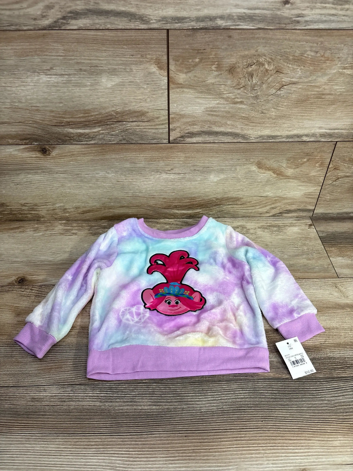 Kids' pastel tie-dye sweatshirt with cartoon character, long sleeves, ribbed cuffs, and tag attached