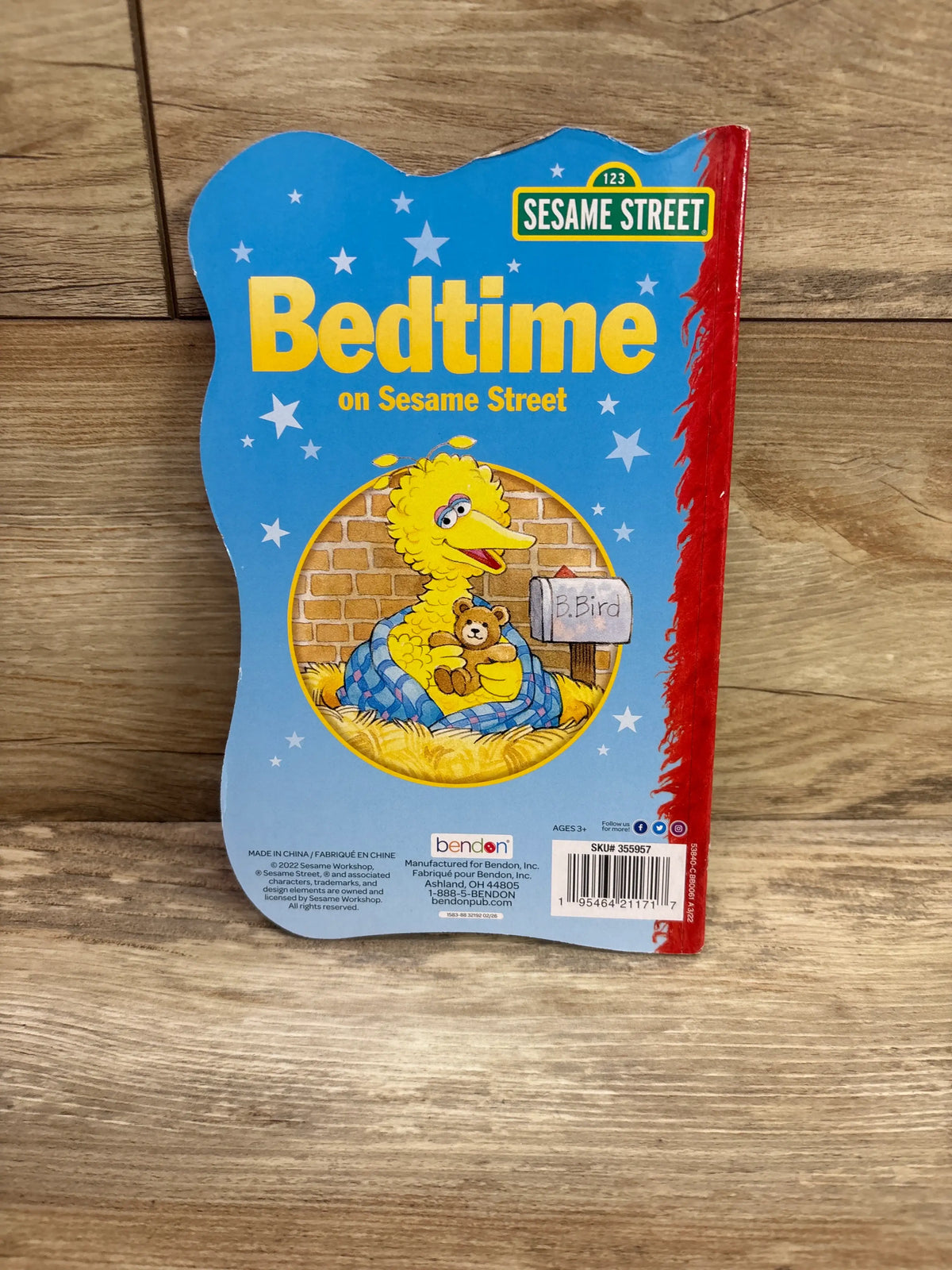 Front cover of Bedtime on Sesame Street hardcover book showing Big Bird with a teddy bear under a blanket against blue stars