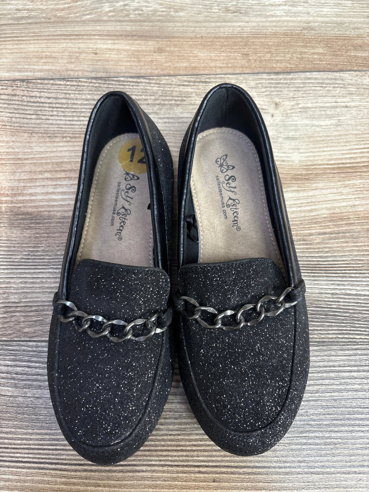 Black glittery loafers with black chain detail on wooden floor, size 12, brand Self Esteem