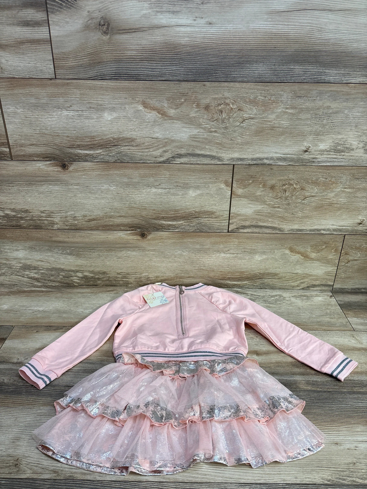 Pink long-sleeve toddler dress with zipper back and sparkly layered tulle skirt on wooden floor