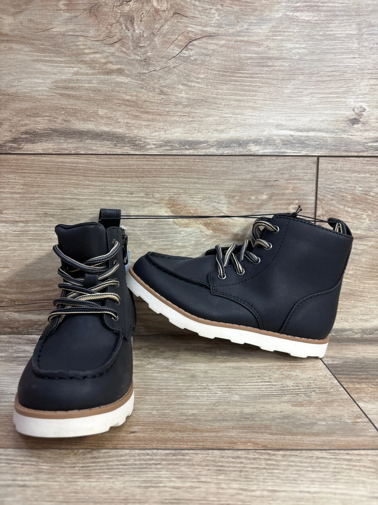 Front and side view of Cat & Jack Greyson black toddler boots, size 11C, lace-up design with white soles on wood background